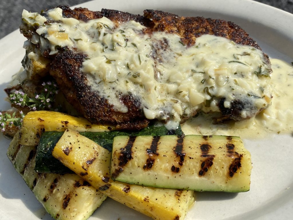 Grilled steak goated in a garlic sauce, and fresh charred zucchini